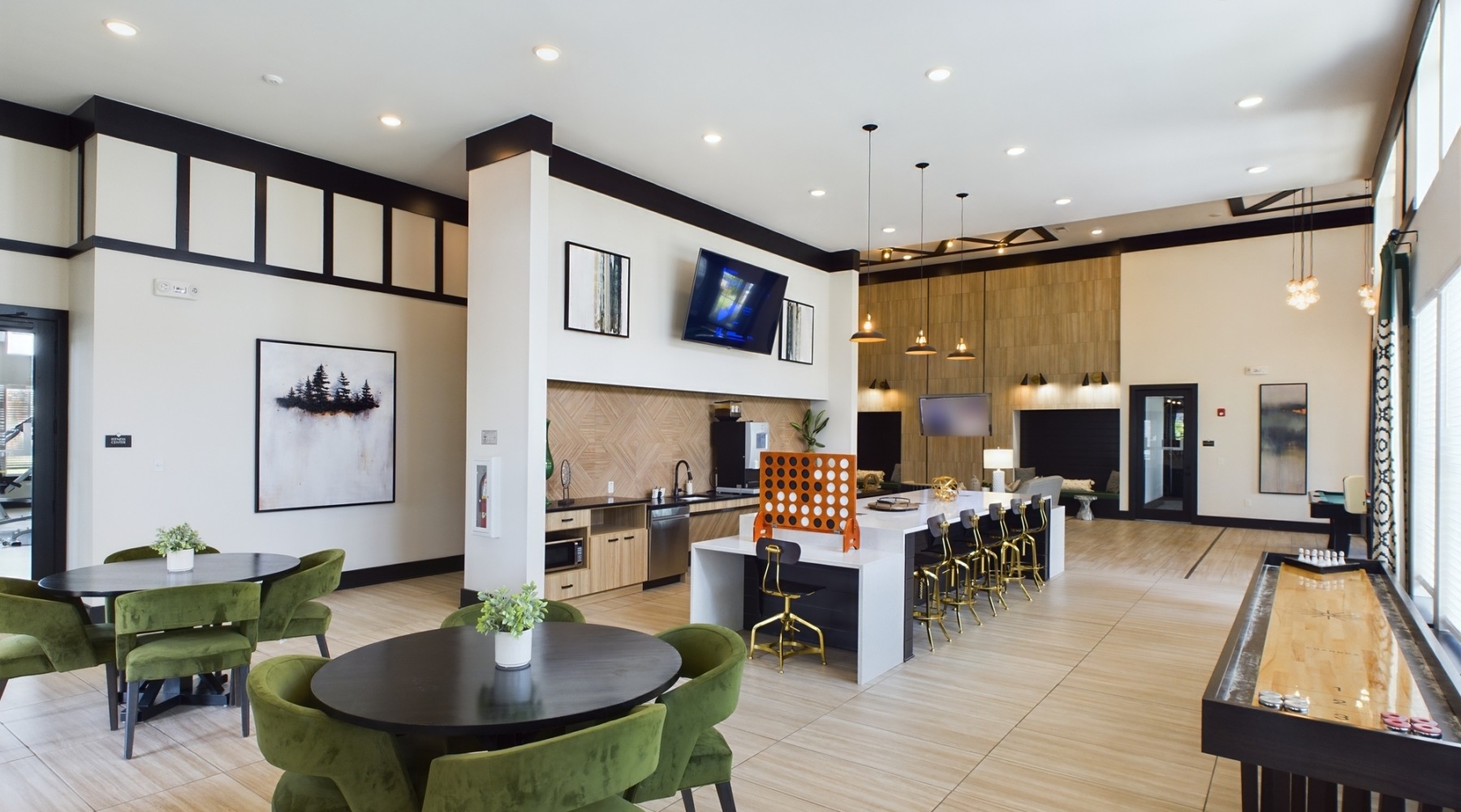 Resident spaces designed for comfort Clubhouse with seating, bar, and shuffleboard table